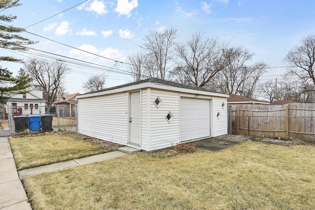 view of outbuilding with driveway, fence, and an outdoor structure