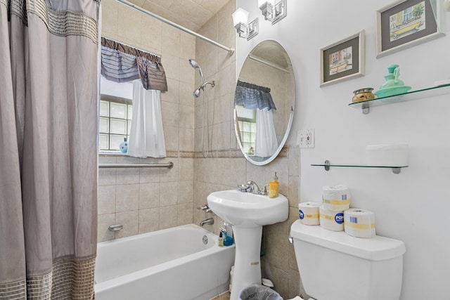 full bath with shower / bath combo with shower curtain and toilet