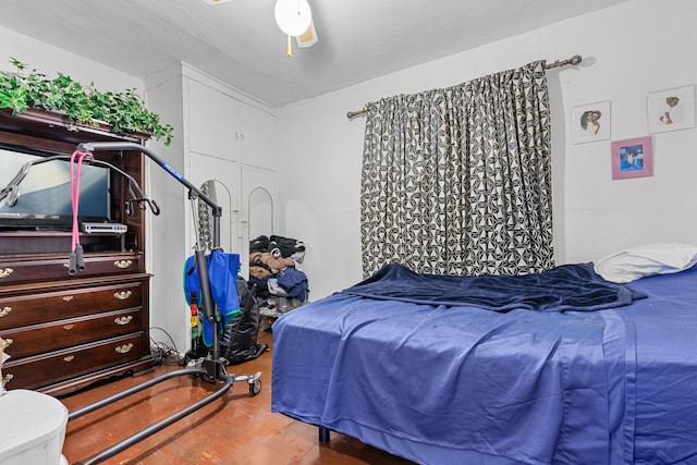 bedroom featuring a ceiling fan and wood finished floors