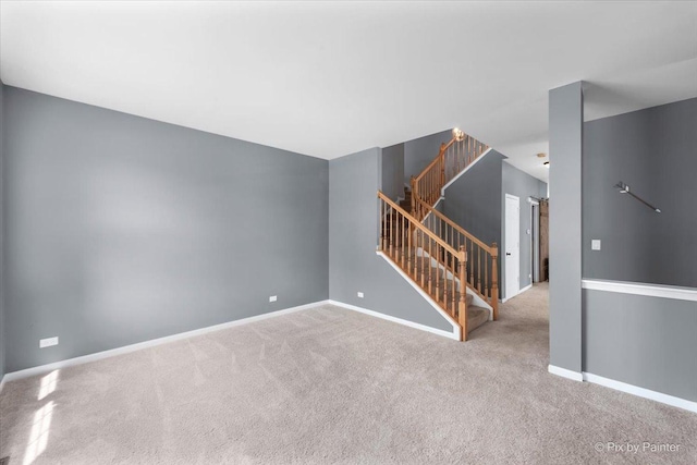 unfurnished room featuring stairs, carpet, and baseboards