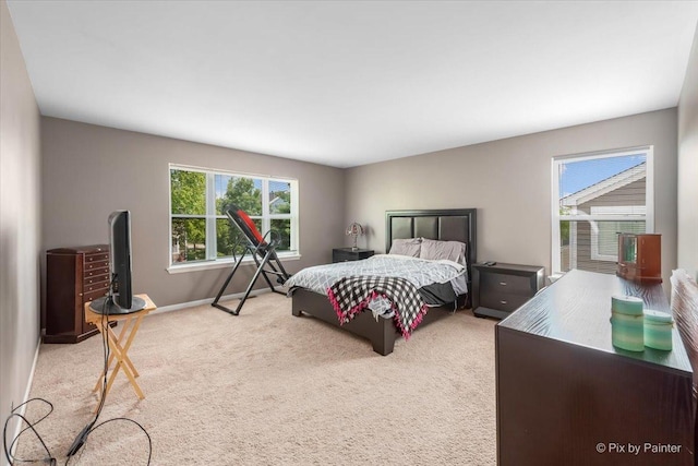 carpeted bedroom featuring baseboards