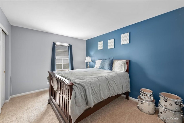 bedroom featuring a closet, baseboards, and carpet flooring