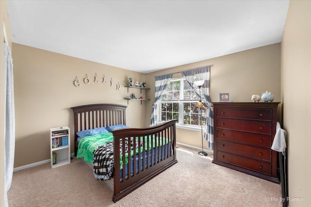 carpeted bedroom featuring baseboards