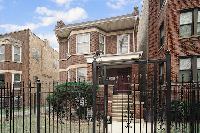 view of front of home with brick siding and a fenced front yard