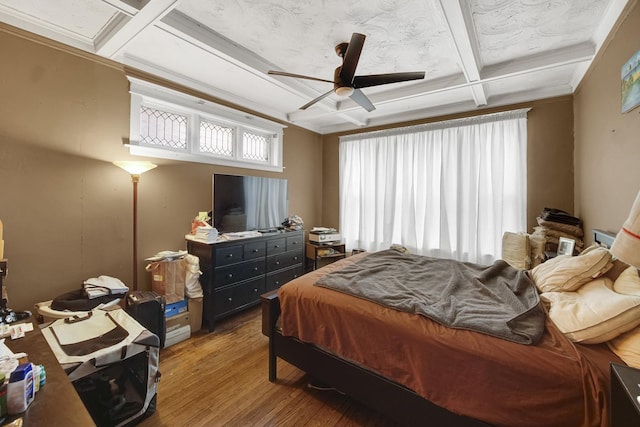 bedroom with beam ceiling, coffered ceiling, ceiling fan, and wood finished floors