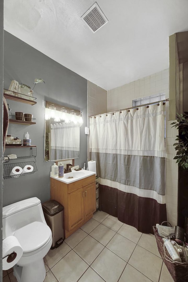 full bathroom featuring tile patterned flooring, visible vents, toilet, a shower with shower curtain, and vanity