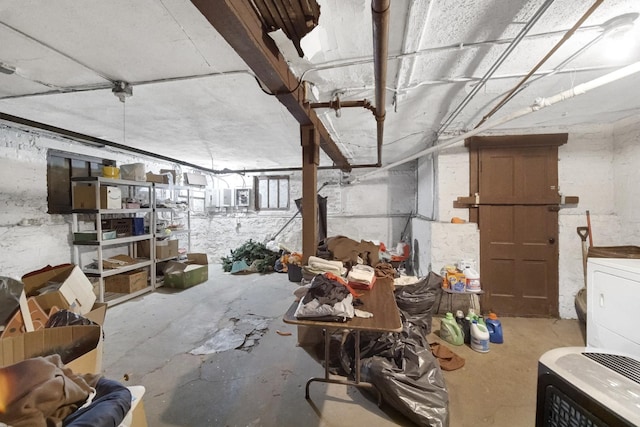 miscellaneous room featuring washer / dryer and concrete floors