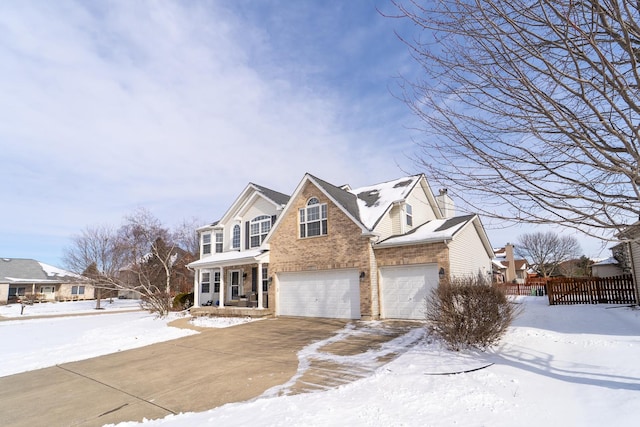 view of front of home with driveway, a garage, fence, and brick siding