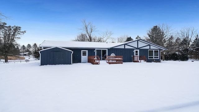 view of snow covered back of property