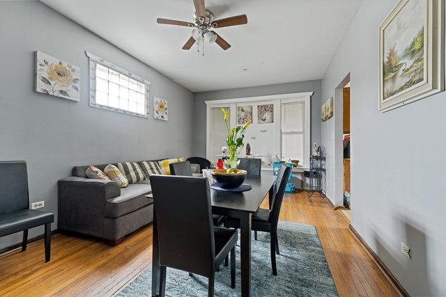 dining space featuring wood-type flooring and ceiling fan