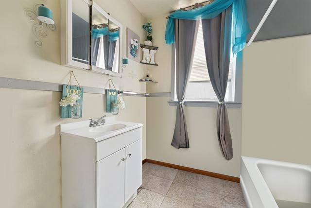 bathroom featuring vanity and a tub