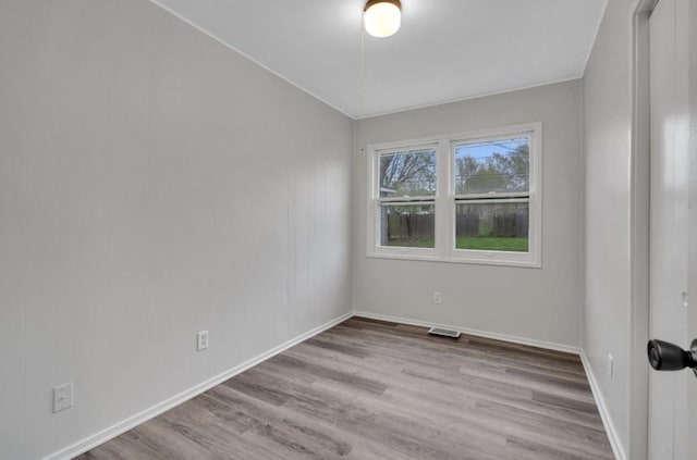 spare room featuring light hardwood / wood-style flooring