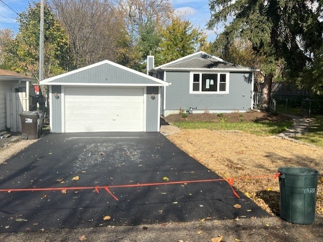 view of front of home with a garage and an outdoor structure