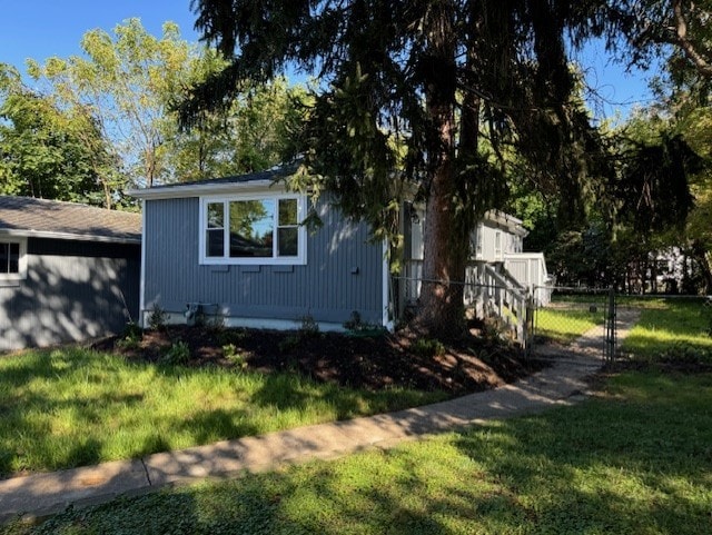 view of side of property with a yard