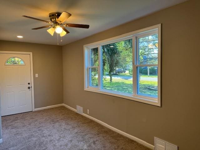 spare room with ceiling fan and carpet floors