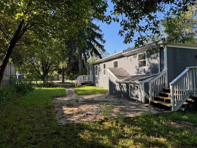 back of house with a lawn