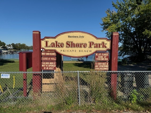 community / neighborhood sign featuring a water view