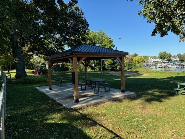 view of community featuring a yard, a gazebo, and a playground