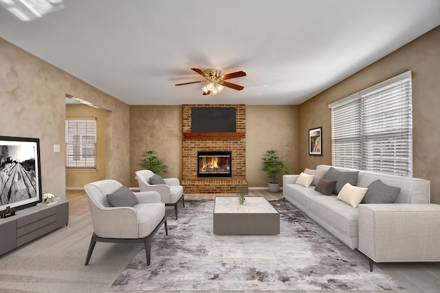 living area with a brick fireplace, baseboards, and ceiling fan