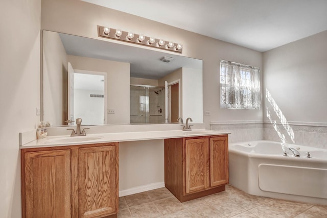 bathroom featuring a bath, tile patterned floors, a stall shower, and vanity