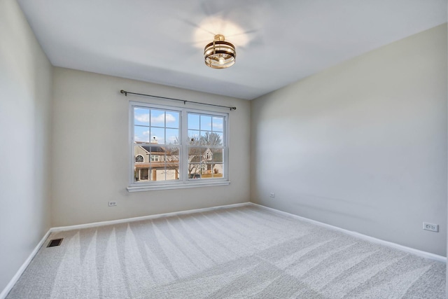 empty room with visible vents, carpet flooring, and baseboards