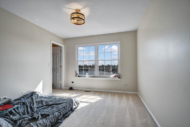 bedroom with visible vents, baseboards, and carpet flooring