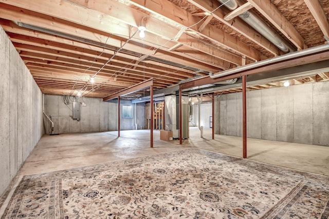 unfinished basement with electric panel and heating unit