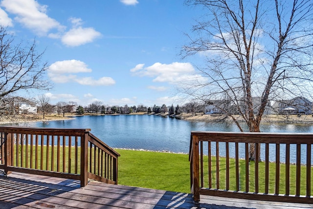 wooden deck featuring a yard and a water view