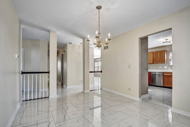 empty room with visible vents, baseboards, marble finish floor, and a chandelier