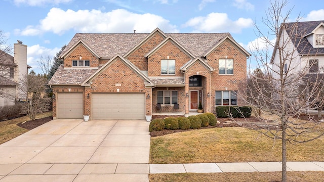 view of front of home featuring a front yard and a garage