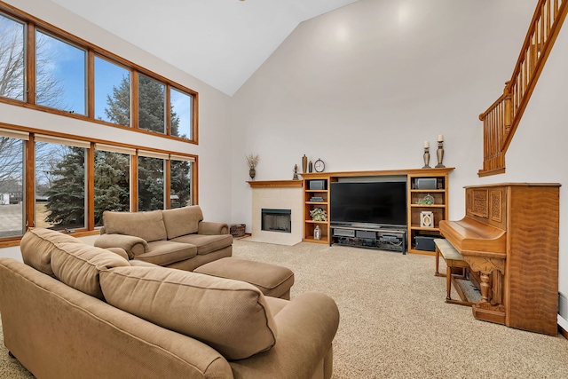 carpeted living room with high vaulted ceiling and a fireplace