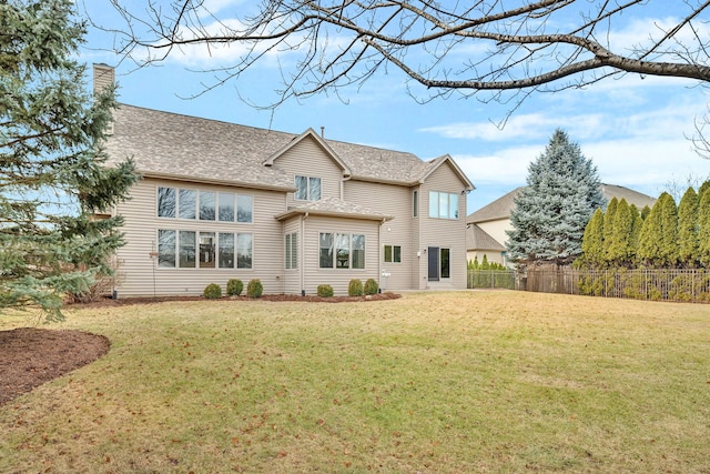 back of house featuring a lawn