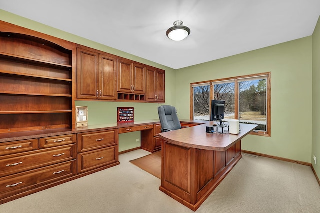 office with light carpet and built in desk