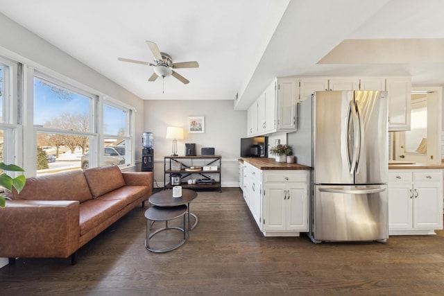 kitchen featuring white cabinets, dark wood finished floors, ceiling fan, freestanding refrigerator, and wooden counters