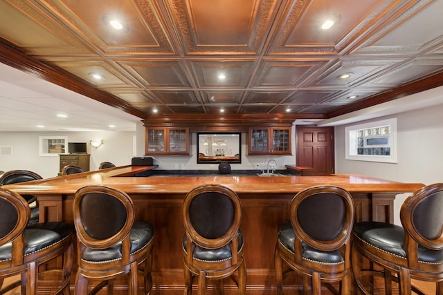 bar with an ornate ceiling, recessed lighting, indoor wet bar, and a sink