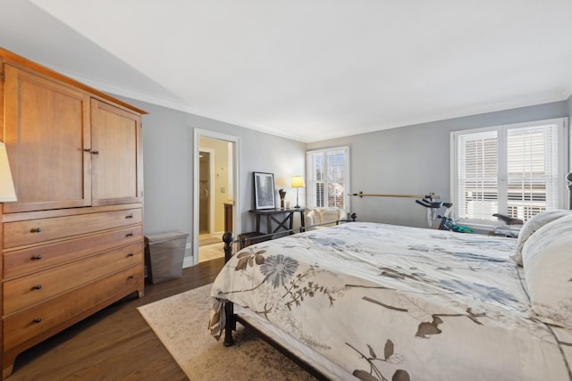 bedroom with ornamental molding, dark wood-type flooring, and ensuite bathroom