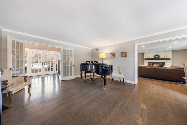 sitting room with ornamental molding, dark wood-type flooring, and french doors