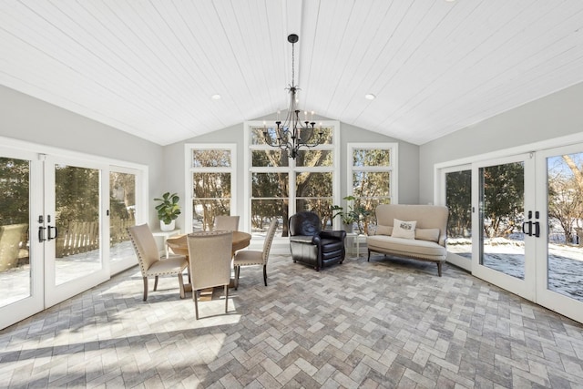 sunroom / solarium with lofted ceiling, french doors, and a notable chandelier