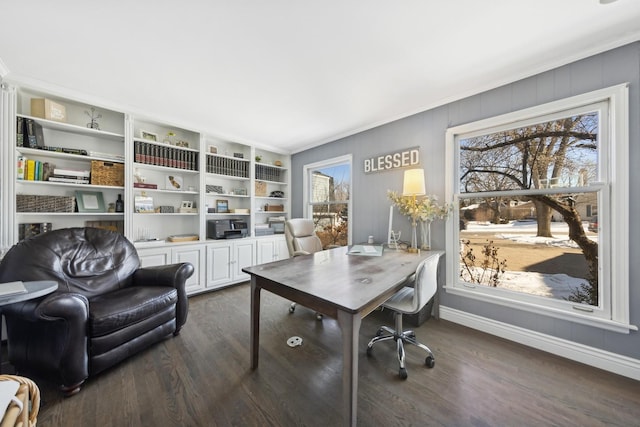 office space with dark wood-style floors, built in shelves, ornamental molding, and baseboards