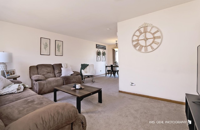 living room featuring light carpet and baseboards