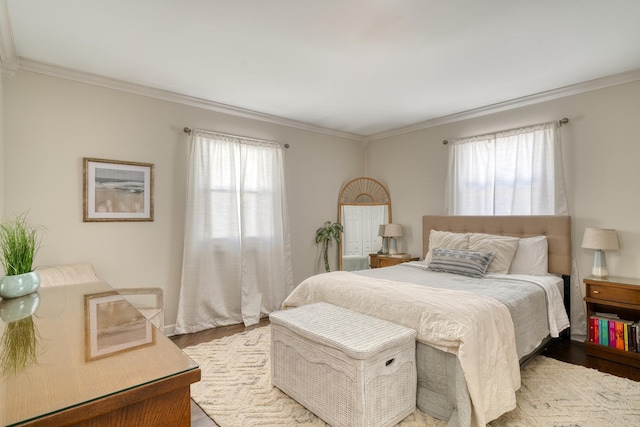 bedroom featuring multiple windows, ornamental molding, and light hardwood / wood-style flooring