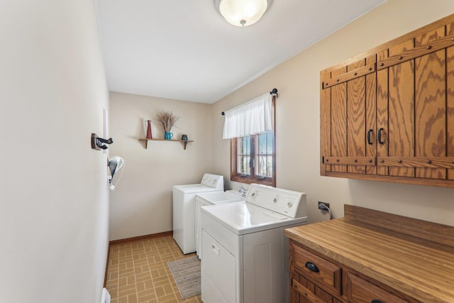 laundry room featuring independent washer and dryer and cabinets