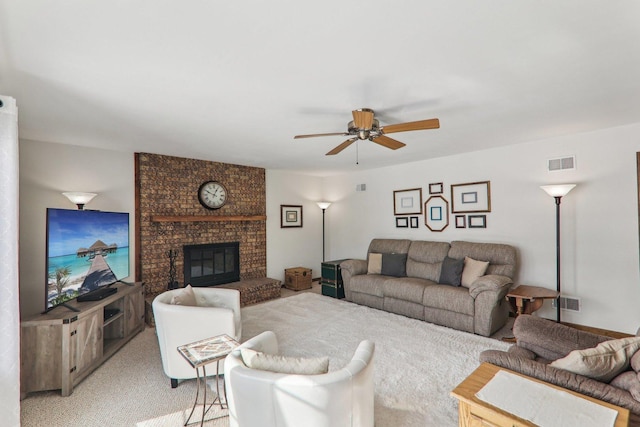 living room featuring ceiling fan, light carpet, and a brick fireplace