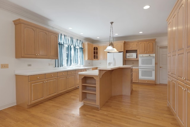 kitchen featuring light hardwood / wood-style flooring, white appliances, a kitchen island, decorative light fixtures, and ornamental molding