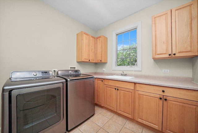 laundry room with sink, washer and clothes dryer, and cabinets