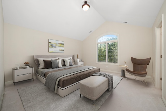 bedroom featuring lofted ceiling and light colored carpet