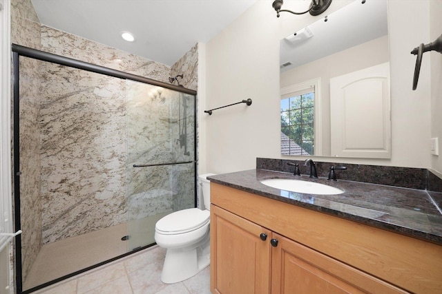 bathroom featuring vanity, a shower with shower door, toilet, and tile patterned flooring