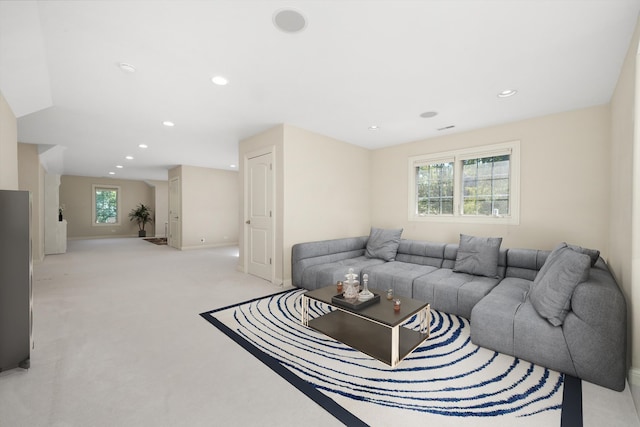 living room with a wealth of natural light and light colored carpet