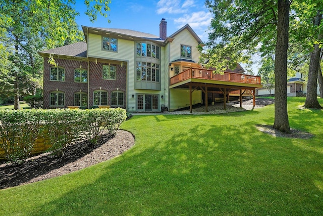 back of property featuring a lawn and a wooden deck