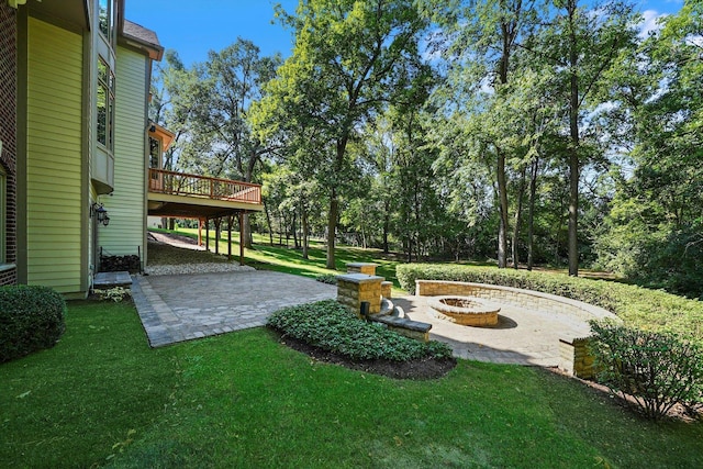 view of yard featuring a patio area, a deck, and a fire pit